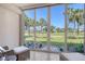 Cozy lanai offering stunning views of the golf course and tropical landscaping at 9470 High Gate Dr # 2213, Sarasota, FL 34238