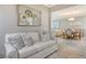 Bright living room flows into a dining area, showcasing an open layout and stylish decor at 9470 High Gate Dr # 2213, Sarasota, FL 34238