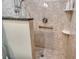 Close-up of the walk-in shower, showing a hand held shower head, and a granite-topped half-wall at 9470 High Gate Dr # 2213, Sarasota, FL 34238