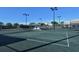 View of the community tennis courts with net and gazebo with seating for players to rest in between games at 9470 High Gate Dr # 2213, Sarasota, FL 34238