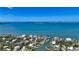Stunning aerial view of a waterfront community with lush landscaping and a beautiful waterway at 975 Whitakers Ln, Sarasota, FL 34236