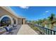 Large balcony with elegant railings and comfortable seating showcasing stunning waterfront views at 975 Whitakers Ln, Sarasota, FL 34236