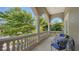 Outdoor balcony featuring decorative pillars, stone railing, and furniture at 975 Whitakers Ln, Sarasota, FL 34236