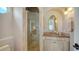 Well-lit bathroom featuring a glass-door shower, granite countertop, and elegant vanity at 975 Whitakers Ln, Sarasota, FL 34236