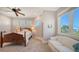 Inviting bedroom with natural light, sitting area, and large windows offering scenic views at 975 Whitakers Ln, Sarasota, FL 34236