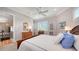 Comfortable bedroom with a ceiling fan, large window with shutters, and beautiful furnishings at 975 Whitakers Ln, Sarasota, FL 34236