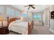 Comfortable bedroom with a plush bed, sitting area, and three windows at 975 Whitakers Ln, Sarasota, FL 34236