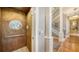 Interior elevator with adjacent staircase with decorative wrought iron at 975 Whitakers Ln, Sarasota, FL 34236