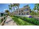 Luxury home exterior showcasing a pool, manicured lawn, and waterfront access at 975 Whitakers Ln, Sarasota, FL 34236