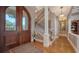 Elegant foyer featuring hardwood floors, a wrought iron staircase, and a grand entryway at 975 Whitakers Ln, Sarasota, FL 34236
