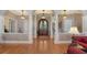 Spacious foyer with hardwood floors, decorative columns, and elegant lighting fixtures at 975 Whitakers Ln, Sarasota, FL 34236