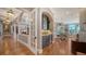 Hallway leading to open living and dining areas with arched openings and detailed woodwork at 975 Whitakers Ln, Sarasota, FL 34236