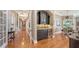 Elegant hallway featuring hardwood floors, archways, built-in wet bar, and access to dining room at 975 Whitakers Ln, Sarasota, FL 34236