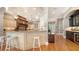 A spacious kitchen with granite countertops, an island bar and modern stainless steel appliances at 975 Whitakers Ln, Sarasota, FL 34236