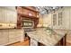 A gourmet kitchen island featuring custom wood detailing, granite countertops and stainless steel appliances at 975 Whitakers Ln, Sarasota, FL 34236