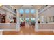 Open-concept living room with tall windows, fireplace, and hardwood floors at 975 Whitakers Ln, Sarasota, FL 34236
