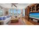 Comfortable living space with a ceiling fan, large windows, and stylish decor at 975 Whitakers Ln, Sarasota, FL 34236