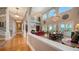 Bright open-concept living area with high ceilings, staircase, fireplace, and access to patio at 975 Whitakers Ln, Sarasota, FL 34236