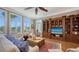 Inviting living room featuring a large window view and custom built-in shelving at 975 Whitakers Ln, Sarasota, FL 34236