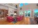Elegant living room with high ceilings, a fireplace, and waterfront views at 975 Whitakers Ln, Sarasota, FL 34236
