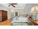 Spacious bedroom featuring hardwood floors, ensuite bathroom, and large windows with natural light at 975 Whitakers Ln, Sarasota, FL 34236