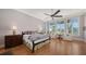 Bright, airy main bedroom boasts large windows, wood floors, and stylish ceiling fan at 975 Whitakers Ln, Sarasota, FL 34236