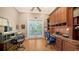 Dedicated office with custom built-ins, dual desks, and balcony access at 975 Whitakers Ln, Sarasota, FL 34236