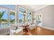 Cozy sun room with water views featuring two upholstered chairs, wood floors, and views of the canal at 975 Whitakers Ln, Sarasota, FL 34236