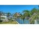 Scenic waterfront view showcasing multiple luxury homes with boat docks and lush palm trees at 975 Whitakers Ln, Sarasota, FL 34236
