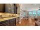 Wet bar area featuring custom cabinetry, granite countertops, and a wine refrigerator at 975 Whitakers Ln, Sarasota, FL 34236