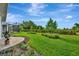 Picture of the lush backyard with a view of the screened-in patio and beautiful landscaping at 10394 Abaco Falls Dr, Englewood, FL 34223