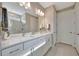 Bright bathroom featuring a marble shower, dual vanity and quartz countertop at 10394 Abaco Falls Dr, Englewood, FL 34223