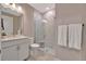 Modern bathroom with white marble, updated vanity, and a frameless glass shower at 10394 Abaco Falls Dr, Englewood, FL 34223