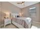 Cozy bedroom featuring a queen-sized bed, bedside tables, and neutral decor for a serene ambiance at 10394 Abaco Falls Dr, Englewood, FL 34223