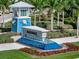 Community entrance with water fountain and a blue, island-style watchtower at 10394 Abaco Falls Dr, Englewood, FL 34223