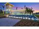 The Beachwalk community entrance features a waterfall and landscaping at sunset at 10394 Abaco Falls Dr, Englewood, FL 34223