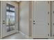 Foyer featuring tiled flooring, a glass panel front door, and white trim at 10394 Abaco Falls Dr, Englewood, FL 34223