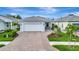 Charming single-story home featuring a brick driveway, two-car garage, and well-maintained landscaping at 10394 Abaco Falls Dr, Englewood, FL 34223