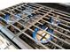 Close-up of a gas range with blue flames, showcasing the appliance's cooktop at 10394 Abaco Falls Dr, Englewood, FL 34223