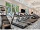 Modern gym featuring treadmills and other cardio equipment with a view of the pool at 10394 Abaco Falls Dr, Englewood, FL 34223