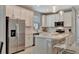 Modern kitchen featuring stainless steel appliances, quartz countertops, and a stylish island with pendant lighting at 10394 Abaco Falls Dr, Englewood, FL 34223