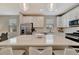 Kitchen island with quartz countertops, stainless steel appliances, and pendant lighting at 10394 Abaco Falls Dr, Englewood, FL 34223