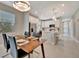 Bright, open-concept kitchen and dining area featuring stainless steel appliances and modern finishes at 10394 Abaco Falls Dr, Englewood, FL 34223