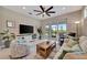 Cozy living room featuring a ceiling fan and sliding glass doors offering picturesque outdoor views at 10394 Abaco Falls Dr, Englewood, FL 34223