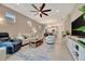 Spacious living area featuring a modern ceiling fan and a comfortable seating arrangement at 10394 Abaco Falls Dr, Englewood, FL 34223