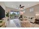 Relaxing living room with sliding glass doors leading to an outdoor space and providing natural light at 10394 Abaco Falls Dr, Englewood, FL 34223