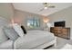 Beautiful bedroom with natural light, a ceiling fan, and a TV over a dresser at 10394 Abaco Falls Dr, Englewood, FL 34223