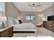 Inviting main bedroom showcasing a comfortable bed, ceiling fan, and stylish furnishings at 10394 Abaco Falls Dr, Englewood, FL 34223