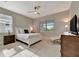 Main bedroom featuring abundant natural light, a ceiling fan, and modern decor at 10394 Abaco Falls Dr, Englewood, FL 34223