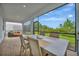Covered patio with a dining table and chairs, perfect for enjoying outdoor meals at 10394 Abaco Falls Dr, Englewood, FL 34223